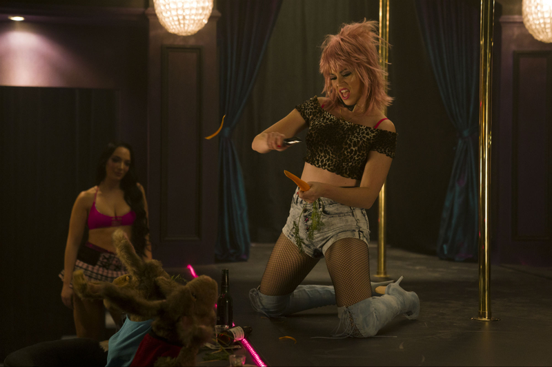 A puppet at a strip club and a stripper (Elizabeth Banks) peeling a carrot. Sure.